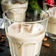 Creamy liqueurs against holiday background